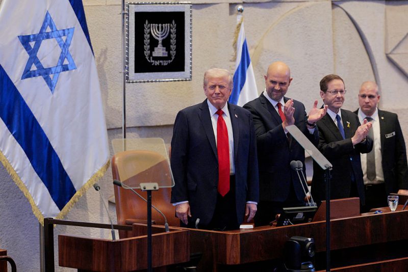 JERUSALEM - OCTOBER 13: U.S. President Donald Trump arrives to address the Knesset, Israel’s parliament, with Amir Ohana, Speaker of the Israeli Knesset, and Israeli President Isaac Herzog on October 13, 2025 in Jerusalem. President Trump is visiting the country hours after Hamas released some of the remaining Israeli hostages captured on Oct. 7, 2023, part of a US-brokered ceasefire deal to end the war in the Gaza Strip. (Photo by Chip Somodevilla/Getty Images)