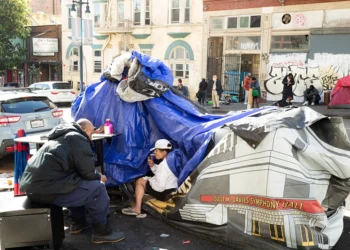 People and their belongings are seen on Jones Street in San Francisco, on November 13, 2023. San Francisco has struggled to clean up the city ahead of hosting world and business leaders. (Photo by Jason Henry / AFP) (Photo by JASON HENRY/AFP via Getty Images)
