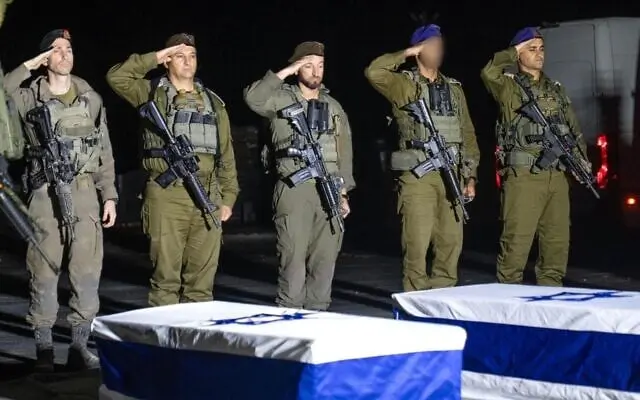 IDF commanders, including Southern Command chief Maj. Gen. Yaniv Asor (2nd from left), Gaza Division commander Brig. Gen. Barak Hiram (center), Givati Brigade commander Col. Netanel Shamaka (right), and 7th Armored Brigade Commander Col. Shaul Israeli, (right) salute over the caskets containing the bodies of Col. Asaf Hamami, Cpt. Omer Neutra, and Staff Sgt. Oz Daniel, during a short ceremony led by IDF Chief Rabbi Brig. Gen. Eyal Krim in the Gaza Strip, late November 2, 2025. (Israel Defense Forces)
