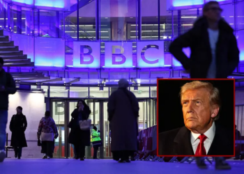 People use the entrance to the offices of British broadcaster BBC in London in the late afternoon on November 11, 2025. The BBC