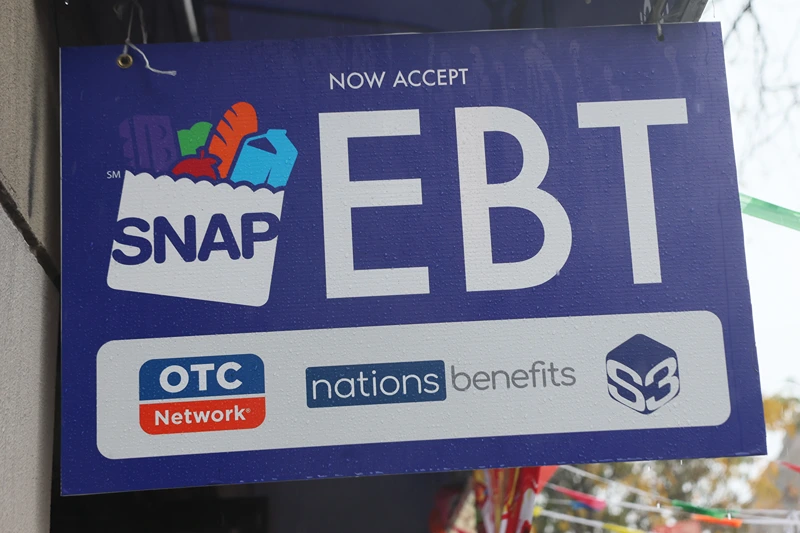 NEW YORK, NEW YORK - OCTOBER 30: An EBT sign is displayed on the window of a grocery store on October 30, 2025 in the Flatbush neighborhood of the Brooklyn borough in New York City. Supplemental Nutrition Assistance Program (SNAP) benefits and other assistance are set to stop on November 1st amid a federal government shutdown that has been going on for 29 days and is the second-longest shutdown in the nation