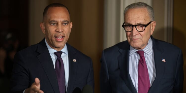 US Senate Minority Leader Sen. Chuck Schumer stands next to House Minority Leader Rep. Hakeem Jeffries as they brief members of the news media regarding the government shutdown at the U.S. Capitol in Washington, DC on Oct. 16, 2025.