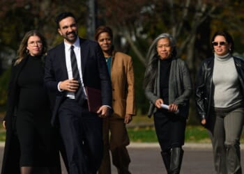Mayor-elect of New York City Zohran Mamdani stands next to members of his transition team in the Queens borough of New York City on Nov. 5, 2025.