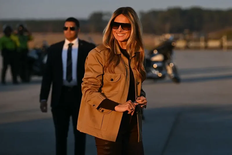 US First Lady Melania Trump smiles as she boards the plane to depart from Albert J. Ellis Airport in Jacksonville, North Carolina, November 19, 2025. First Lady Melania Trump and Second Lady Usha Vance are returning to Washington after visiting military families at Marine Corps Air Station New River in Jacksonville, North Carolina. (Photo by SAUL LOEB / AFP) (Photo by SAUL LOEB/AFP via Getty Images)