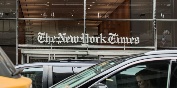 Cars and cabs drive outside of The New York Times corporate headquarters in Times Square, Manhattan, New York City.