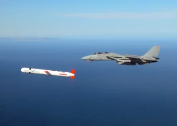 A Tactical "Tomahawk" Block IV cruise missile is escorted by a Navy F-14 "Tomcat" fighter during a controlled test over the Naval Air Systems Command (NAVAIR) western test range complex in southern California. The Tactical Tomahawk, scheduled to join the fleet in 2004, is the next generation of Tomahawk cruise missile and it adds the capability to reprogram the missile while in-flight to strike any of 15 preprogrammed alternate targets or redirect the missile to any Global Positioning System (GPS) target coordinates. Warplanes from a US-British coalition bombed communications facilities in the south of the country after an Iraqi military jet violated the no-fly zone, the US military said 22 November. AFP PHOTO/US NAVY HO (Photo by US NAVY / AFP) (Photo by -/US NAVY/AFP via Getty Images)