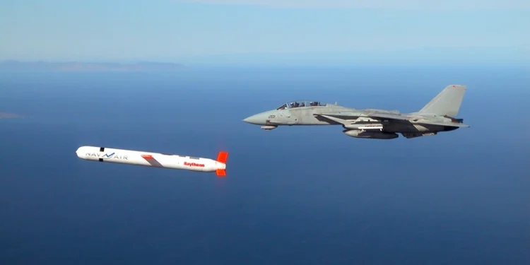 A Tactical "Tomahawk" Block IV cruise missile is escorted by a Navy F-14 "Tomcat" fighter during a controlled test over the Naval Air Systems Command (NAVAIR) western test range complex in southern California. The Tactical Tomahawk, scheduled to join the fleet in 2004, is the next generation of Tomahawk cruise missile and it adds the capability to reprogram the missile while in-flight to strike any of 15 preprogrammed alternate targets or redirect the missile to any Global Positioning System (GPS) target coordinates. Warplanes from a US-British coalition bombed communications facilities in the south of the country after an Iraqi military jet violated the no-fly zone, the US military said 22 November. AFP PHOTO/US NAVY HO (Photo by US NAVY / AFP) (Photo by -/US NAVY/AFP via Getty Images)