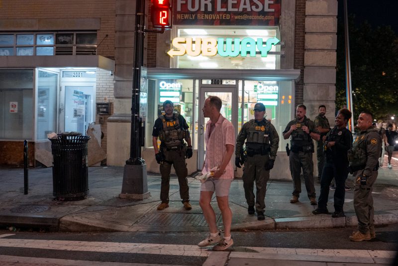 WASHINGTON, DC - AUGUST 10: FBI and Border Patrol officers speak with Sean Charles Dunn, after he allegedly assaulted law enforcement with a sandwich, along the U Street corridor during a federal law enforcement deployment to the nation's capital on August 10, 2025 in Washington, DC. U.S. President Donald Trump ordered an increased presence of federal law enforcement in Washington, DC, in an effort to curb crime. (Photo by Andrew Leyden/Getty Images).