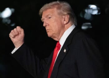 President Donald Trump gestures as he walks on the South Lawn of the White House in Washington, D.C., on Sunday.