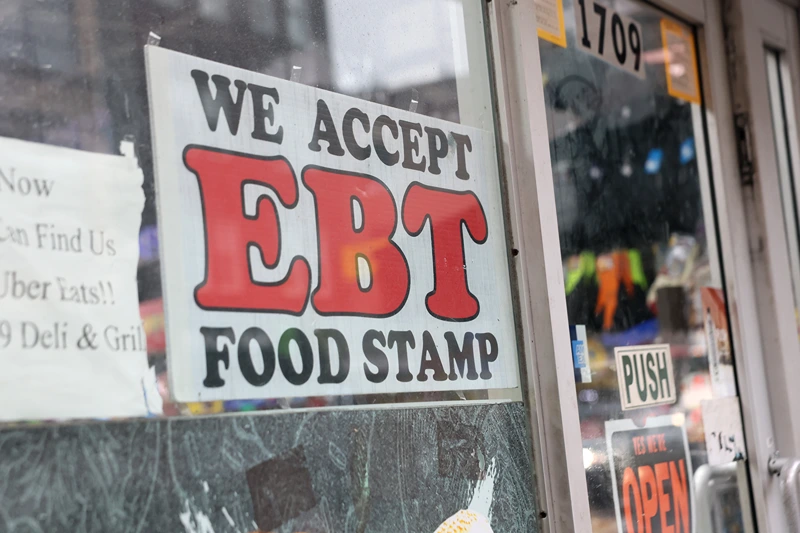 NEW YORK, NEW YORK - OCTOBER 30: An EBT sign is displayed on the window of a grocery store on October 30, 2025 in the Flatbush neighborhood of the Brooklyn borough in New York City. Supplemental Nutrition Assistance Program (SNAP) benefits and other assistance are set to stop on November 1st amid a federal government shutdown that has been going on for 29 days and is the second-longest shutdown in the nation