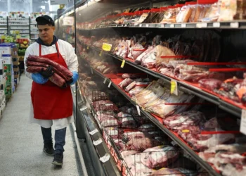 MIAMI, FLORIDA - JULY 22: Marlo Ramirez carries slabs of beef to be prepared for a customer in a grocery store on July 22, 2025 in Miami, Florida. Beef prices are hitting records, rising almost 9% since January, according to the Department of Agriculture. Industry experts say the increase in prices are due in part to drought conditions across the country that have caused herds to shrink, while the demand for beef continues to increase. (Photo by Joe Raedle/Getty Images)