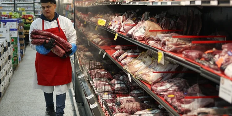 MIAMI, FLORIDA - JULY 22: Marlo Ramirez carries slabs of beef to be prepared for a customer in a grocery store on July 22, 2025 in Miami, Florida. Beef prices are hitting records, rising almost 9% since January, according to the Department of Agriculture. Industry experts say the increase in prices are due in part to drought conditions across the country that have caused herds to shrink, while the demand for beef continues to increase. (Photo by Joe Raedle/Getty Images)