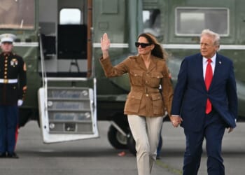 President Donald Trump and First Lady Melania Trump walk across the tarmac from the Marine One helicopter toward Air Force One at Stansted Airport, in Stansted, north of London, on Sept. 18, 2025.