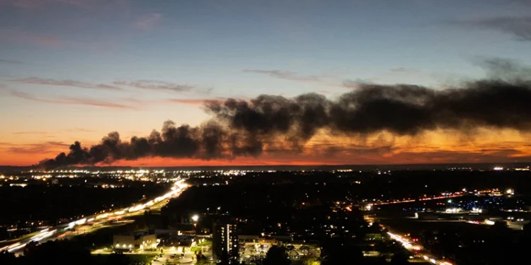 TOPSHOT - Smoke rises from the site of a UPS cargo plane crash near the UPS Worldport at Louisville Muhammad Ali International Airport in Louisville, Kentucky, on November 4, 2025. A UPS cargo plane crashed on the evening of November 11 near the Louisville International Airport shortly after takeoff, the US Federal Aviation Administration (FAA) said, as local media in the Kentucky city aired video of a large plume of smoke rising above the facility."UPS Flight 2976 crashed around 5:15 p.m. local time," the FAA said, identifying the aircraft as a McDonnell Douglas MD-11 headed to Hawaii. (Photo by LEANDRO LOZADA / AFP) / ALTERNATE CROP (Photo by LEANDRO LOZADA/AFP via Getty Images)