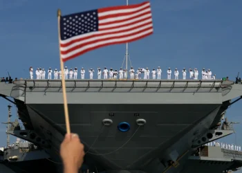 NORFOLK, VIRGINIA - JUNE 24: U.S. Navy sailors stand along the deck as they prepare for the aircraft carrier USS Gerald R. Ford to depart from the Naval Station Norfolk on June 24, 2025, in Norfolk, Virginia. The aircraft carrier is leaving on its scheduled deployment to the U.S. European Command area of responsibility. The deployment comes during the ongoing conflict in the Middle East between Israel and Iran. (Photo by Joe Raedle/Getty Images)