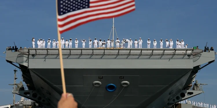 NORFOLK, VIRGINIA - JUNE 24: U.S. Navy sailors stand along the deck as they prepare for the aircraft carrier USS Gerald R. Ford to depart from the Naval Station Norfolk on June 24, 2025, in Norfolk, Virginia. The aircraft carrier is leaving on its scheduled deployment to the U.S. European Command area of responsibility. The deployment comes during the ongoing conflict in the Middle East between Israel and Iran. (Photo by Joe Raedle/Getty Images)