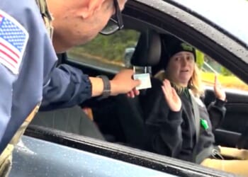 "I'm just a mom," an Oregon agitator whined after a federal officer confronted her for aggressively following and trying to block vehicles during an immigration enforcement operation.