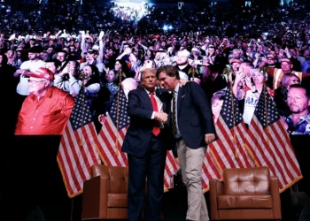 PHOENIX, ARIZONA - OCTOBER 31: Republican presidential nominee, former President Donald Trump shakes hands with Tucker Carlson at the conclusion of a conversation during Carlson