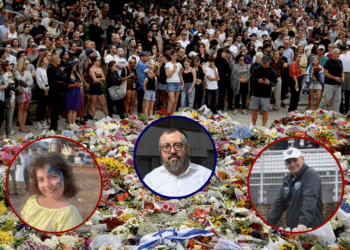Mourners gather by floral tributes at the Bondi Pavillion in memory of the victims of a shooting at Bondi Beach, in Sydney on December 15, 2025. A father and son opened fire on a Jewish festival at Australia
