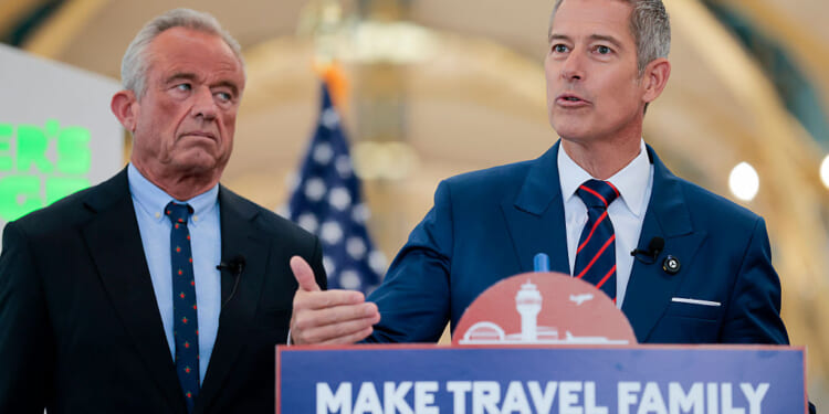 ARLINGTON, VA - DECEMBER 08: U.S. Transportation Secretary Sean P. Duffy (R) speaks alongside Human Services Secretary Robert F. Kennedy Jr. at a conference discussing the launch of the "Make Travel Family Friendly Again" campaign at Ronald Reagan Washington National Airport on December 08, 2025 in Arlington, Virginia. The campaign
