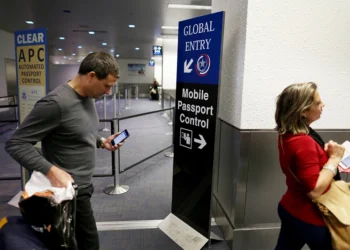 MIAMI, FL - MARCH 04: A sign points passengers to the mobile passport control window set up for international travelers arriving at Miami International Airport on March 4, 2015 in Miami, Florida. Miami-Dade Aviation Department and U.S. Customs and Border Protection (CBP) unveiled a new mobile app for expedited passport and customs screening. The app for iOS and Android devices allows U.S. citizens and some Canadian citizens to enter and submit their passport and customs declaration information using their smartphone or tablet and to help avoid the long waits in the exit lanes. (Photo by Joe Raedle/Getty Images)