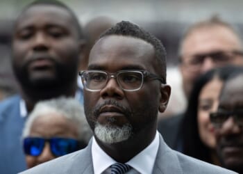 Chicago Mayor Brandon Johnson listens as Illinois Gov. J.B. Pritzker speaks at a news conference to address President Donald Trump's plan to send National Guard troops into the city on Aug. 25, 2025, in Chicago, Illinois.