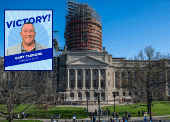 (Background) People, many of whom are adolescents, gather during a rally to protest the passing of SB 150 on March 29, 2023 at the Kentucky State Capitol in Frankfort, Kentucky. SB 150, which was proposed by State Senator Max Wise (R-KY), is criticized by many as a "Don