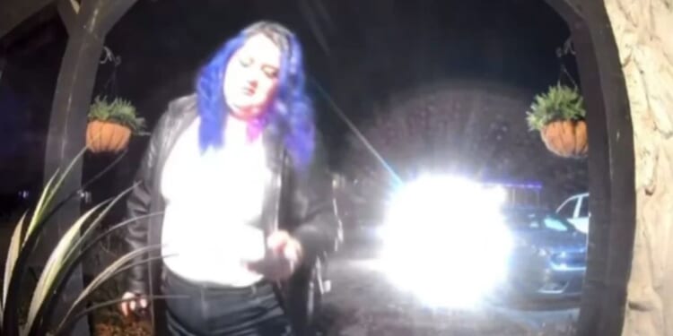 A DoorDash driver with blue hair was allegedly caught by a doorbell camera spiking an innocent woman's meal.