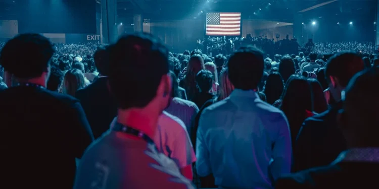 Attendees face the US flag during the national anthem at Turning Point
