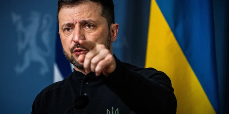 Ukrainian President Volodymyr Zelensky gestures as he addresses a press conference with the Norwegian Prime Minister in the government