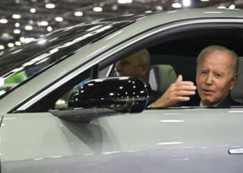 Then-President Joe Biden sits at the wheel of a Cadillac Lyriq electric vehicle as he visits the 2022 North American International Auto Show in Detroit, Michigan, on Sept. 14, 2022.