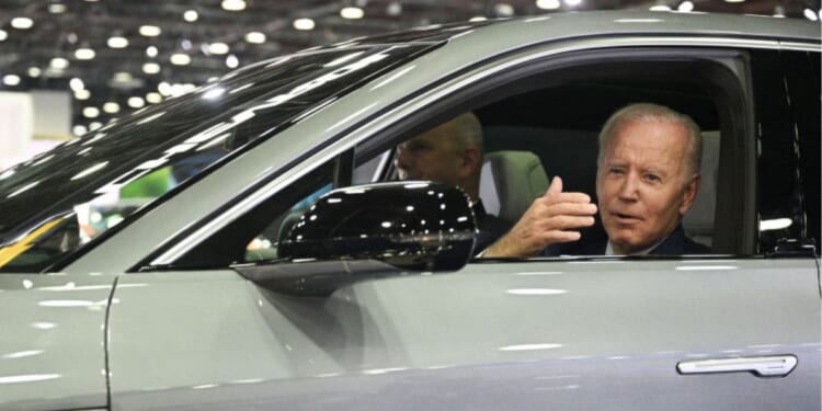 Then-President Joe Biden sits at the wheel of a Cadillac Lyriq electric vehicle as he visits the 2022 North American International Auto Show in Detroit, Michigan, on Sept. 14, 2022.