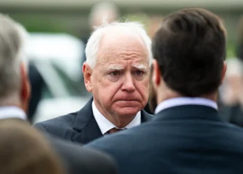 MINNEAPOLIS, MINNESOTA - JUNE 28: Minnesota Gov. Tim Walz presents a Minnesota flag to the family of DFL Rep. Melissa Hortman and her husband Mark Hortman after a funeral ceremony at the Basilica of Saint Mary on June 28, 2025 in Minneapolis, Minnesota. Law enforcement agencies captured Vance Boelter on June 15th in connection with the killing of Rep. Hortman and her husband, Mark, who were shot at their home on June 14th. DFL State Sen. John Hoffman and his wife were also shot and hospitalized in a separate incident. Minnesota Gov. Tim Walz said during a press conference that the shooting "appears to be a politically motivated assassination." (Photo by Stephen Maturen/Getty Images)