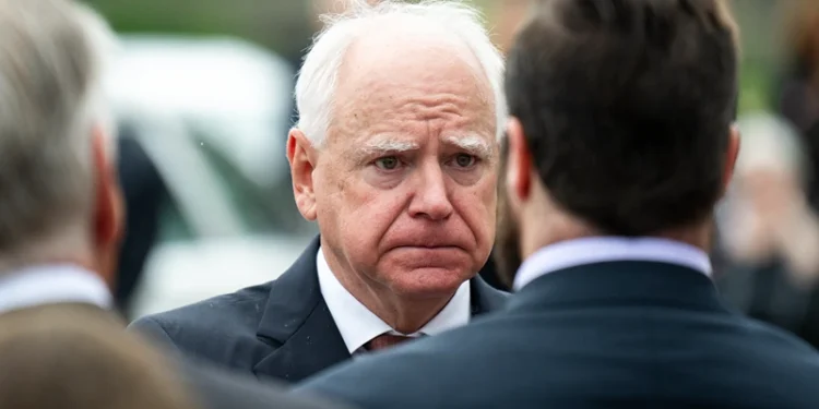 MINNEAPOLIS, MINNESOTA - JUNE 28: Minnesota Gov. Tim Walz presents a Minnesota flag to the family of DFL Rep. Melissa Hortman and her husband Mark Hortman after a funeral ceremony at the Basilica of Saint Mary on June 28, 2025 in Minneapolis, Minnesota. Law enforcement agencies captured Vance Boelter on June 15th in connection with the killing of Rep. Hortman and her husband, Mark, who were shot at their home on June 14th. DFL State Sen. John Hoffman and his wife were also shot and hospitalized in a separate incident. Minnesota Gov. Tim Walz said during a press conference that the shooting "appears to be a politically motivated assassination." (Photo by Stephen Maturen/Getty Images)
