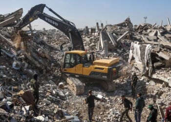 Palestinian Hamas militants and Egyptian workers accompanied by members of the International Committee of the Red Cross use a digger as they search for the last two remaining bodies of hostages, an Israeli soldier and a Thai national, under the rubble of the Jabalia refugee camp, in the northern of Gaza Strip on Dec. 1, 2025.