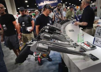National Rifle Association members look over pistols in the Smith & Wesson display at the 146th NRA Annual Meetings & Exhibits on April 29, 2017 in Atlanta, Georgia
