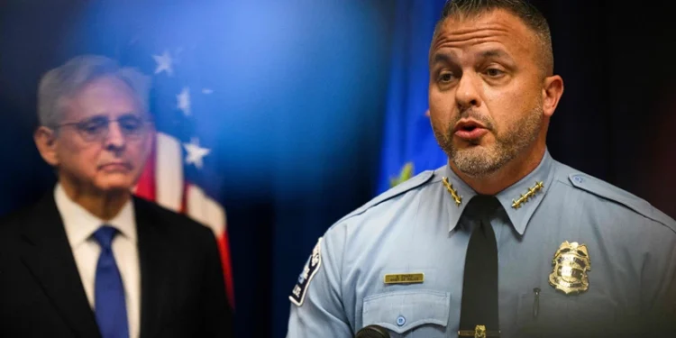 US Attorney General Merrick B. Garland (L) looks on as Minneapolis Police Chief Brian O