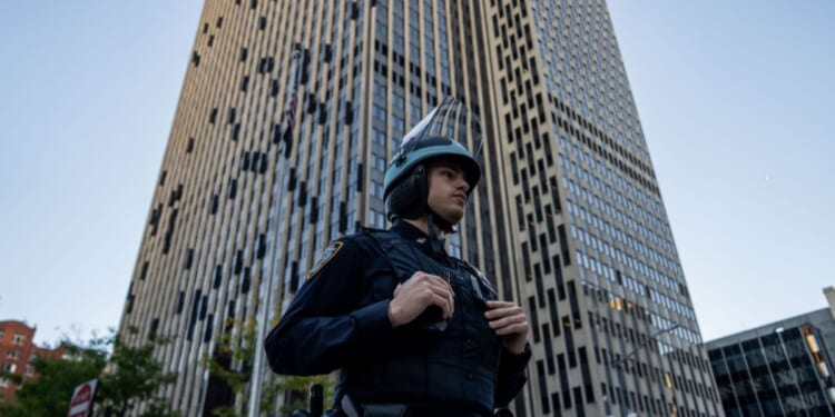An NYPD Strategic Response Group officer stands guard outside of 26 Federal Plaza on Oct. 21, 2025, in New York City.
