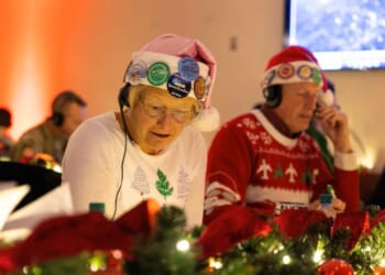 Volunteers take phone calls for the NORAD Santa Tracker (Photo via: U.S. Department of War)