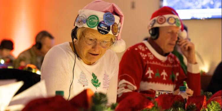 Volunteers take phone calls for the NORAD Santa Tracker (Photo via: U.S. Department of War)