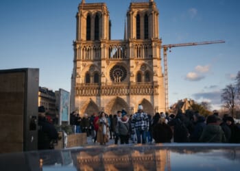 Notre Dame Cathedral looms large over pedestrians in Paris on Christmas Eve.
