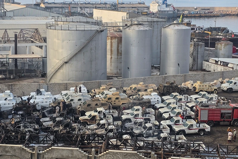 A photograph shows damaged military vehicles, reportedly sent by the United Arab Emirates to support Southern Transitional Council (STC) separatist forces, following an air strike carried out by the Saudi-led coalition in the port of Mukalla, southern Yemen, on December 30, 2025. Saudi Arabia on December 30 called the UAE's support for the separatist offensive in Yemen a threat to the kingdom and regional security, hours after a Riyadh-led coalition launched strikes against the Emirati-backed forces. (Photo by AFP via Getty Images)