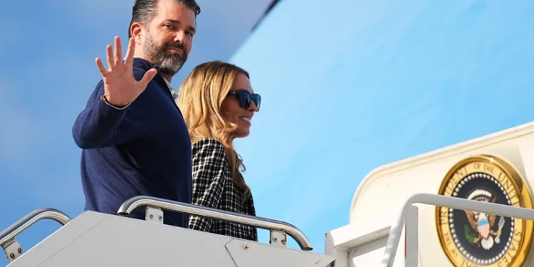 LOSSIEMOUTH, SCOTLAND - JULY 29: Donald Trump Jr. with partner Bettina Anderson prepare to board Air Force One at RAF Lossiemouth, on July 29, 2025 in Lossiemouth, Scotland. President Trump visited Scotland on a trip that was part-vacation, part-work, as he stayed at his Trump Turnberry golf course, followed by the Trump International Golf Links in Aberdeenshire, between July 25 to 29. (Photo by Andrew Harnik/Getty Images)