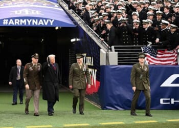 US President Donald Trump waves as he arrives on the field before the college football game between the US Army and Navy at the M&T Bank Stadium in Baltimore, Maryland, on December 13, 2025. (Photo by Alex WROBLEWSKI / AFP via Getty Images)