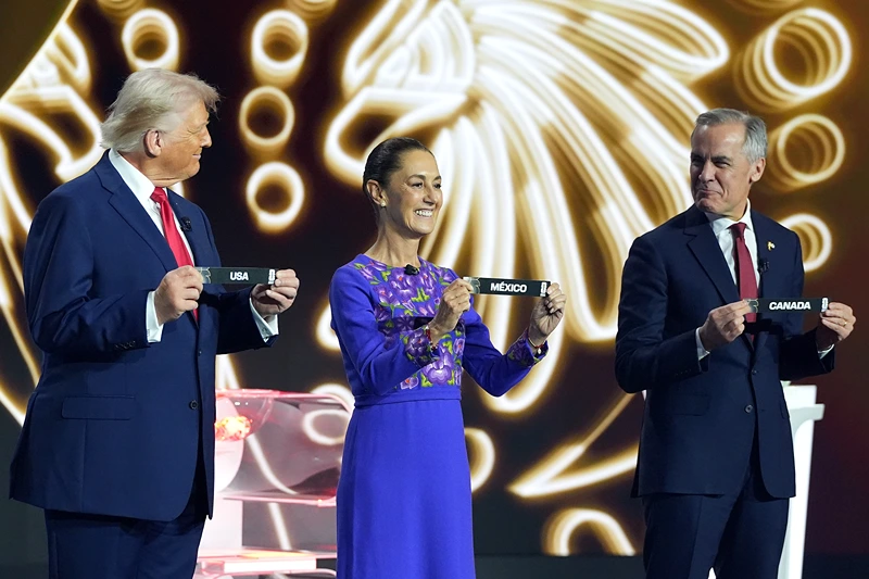 WASHINGTON, DC - DECEMBER 05: U.S. President Donald Trump, Claudia Sheinbaum, President of Mexico, and Mark Carney, Prime Minister of Canada, show the draw on stage during the FIFA World Cup 2026 Official Draw at John F. Kennedy Center for the Performing Arts on December 05, 2025 in Washington, DC. (Photo by Stephanie Scarbrough - Pool/Getty Images)