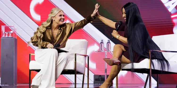 PHOENIX, ARIZONA - DECEMBER 21: Erika Kirk and Nicki Minaj high-five during an interview on the final day of Turning Point USA