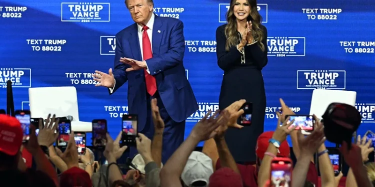 Former US President and Republican presidential candidate Donald Trump, with moderator and South Dakota Governor Kristi Noem (R), arrives for a town hall at the Greater Philadelphia Expo Center and Fairgrounds in Oaks, Pennsylvania, on October 14, 2024. (Photo by Jim WATSON / AFP) (Photo by JIM WATSON/AFP via Getty Images)