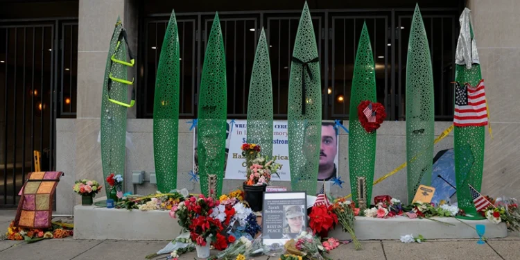WASHINGTON, DC - DECEMBER 01: A makeshift memorial of flowers and American flags stands outside the Farragut West Metro station on December 01, 2025 in Washington, DC. Sarah Beckstrom, one of the two West Virginia National Guard troops who were shot blocks from the White House on November 26, died on Thursday, November 27, following what authorities called a targeted attack. (Photo by Heather Diehl/Getty Images)