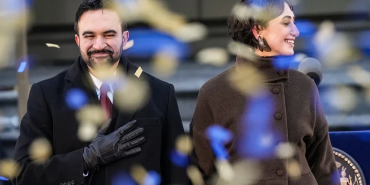 NEW YORK, NEW YORK - JANUARY 01: New York Mayor Zohran Mamdani and his wife Rama Duwaji smile as confetti falls after his ceremonial inauguration as mayor at City Hall Thursday January 1, 2026 in New York, NY. Mamdani has added a “block party” to the official inauguration events to allow thousands of New Yorkers to take part. Mamdani was officially sworn in at midnight by New York Attorney General Letitia James at the Old City Hall subway station in a private ceremony. (Photo by David Dee Delgado/Getty Images)