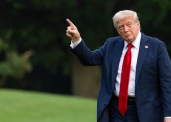 U.S. President Donald Trump walks on the south lawn of the White House and points up at the new flag on July 13, 2025 in Washington, DC.
